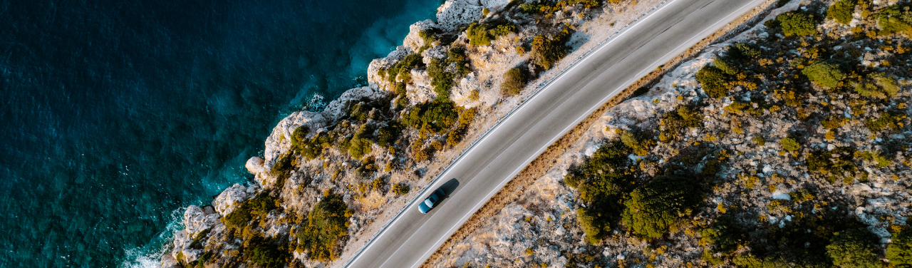 Car driving along the coastline
