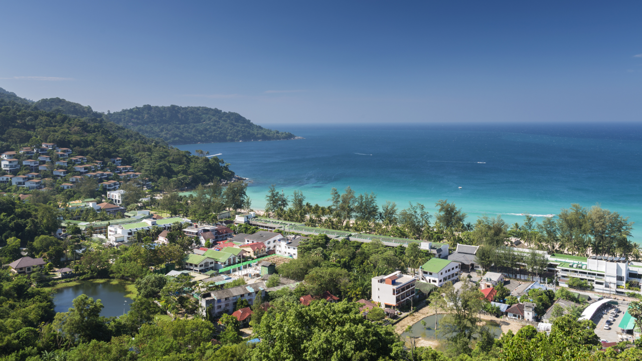 Landscape aerial view of the coastline of Kata beach on the resort island of Phuket in Thailand. Phuket is a world wide famous destination for tourism and people in search of beach, sun and crystal waters.