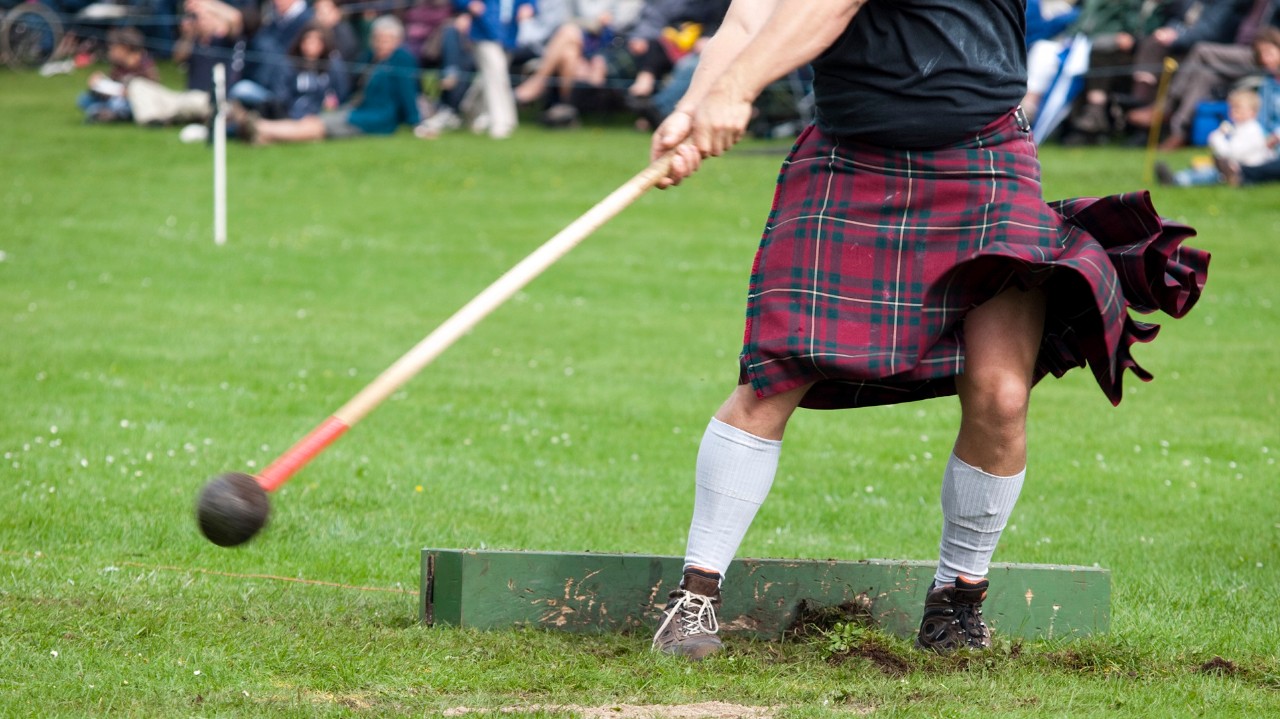 A competitor throwing the hammer at a Highland Games event in Scotland
